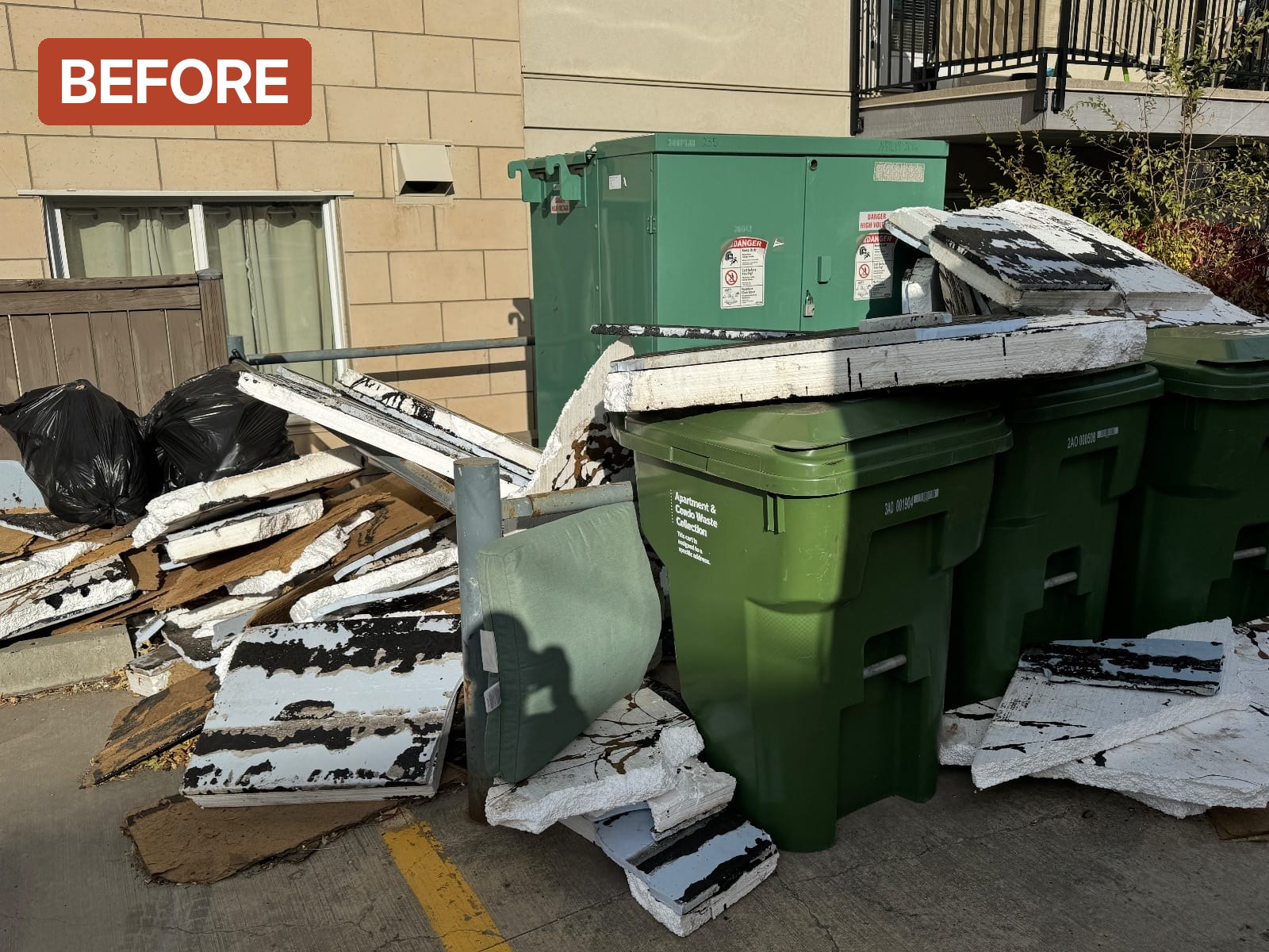Condo bin area before: ceiling tiles, insulation and bags piled around the carts